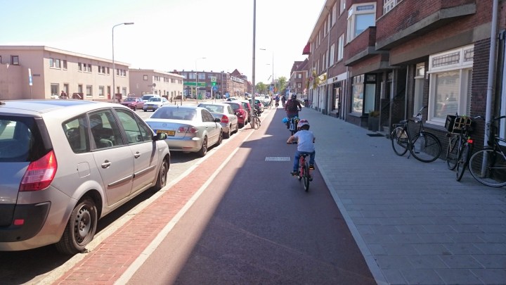 Typical distributor road with parking and segregated cycleway in The Netherlands