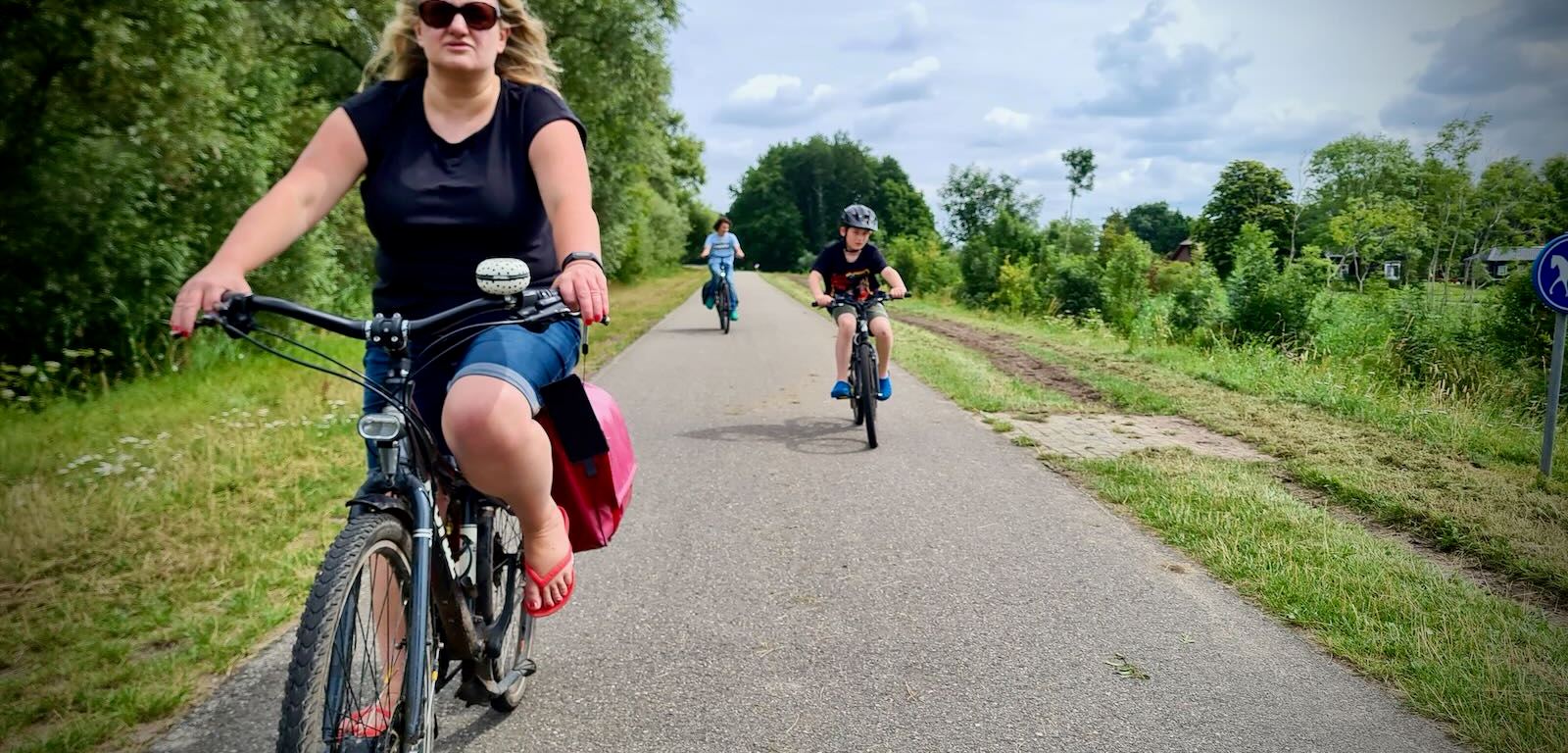 The family riding along the cycle path in Vlietland, horse-friendly path running parallel on the right