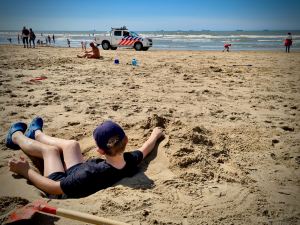 Our youngest in a hole as the police go past