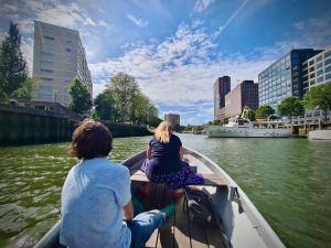 Boating along Boerengat, with boats and buildings in the distance