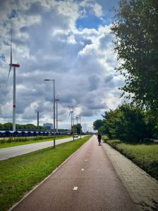 A very straight Westhavenweg, turbines on the left