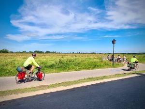 People cycling past, definitely not locals with all that hi-vis and helmets!