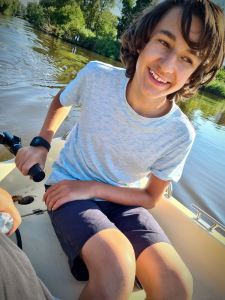 Our eldest driving the boat