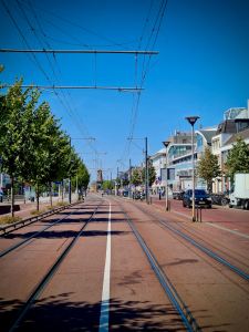 Tram lines along Phoenixstraat, Molen de Roos windmill in the distance