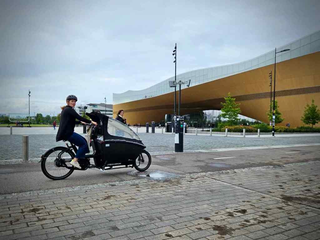 Urban Arrow cargo bike outside the Oodi Library on the path to the Kaisantunneli