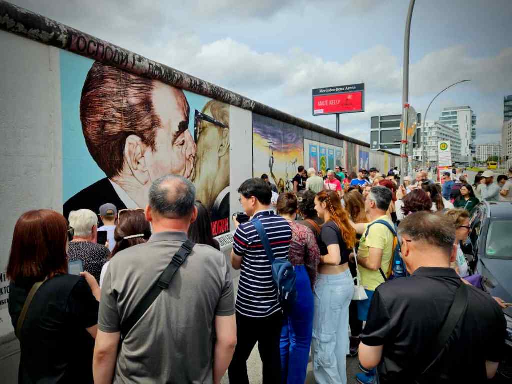 Busy in front of the artwork 'My God, Help Me to Survive This Deadly Love'