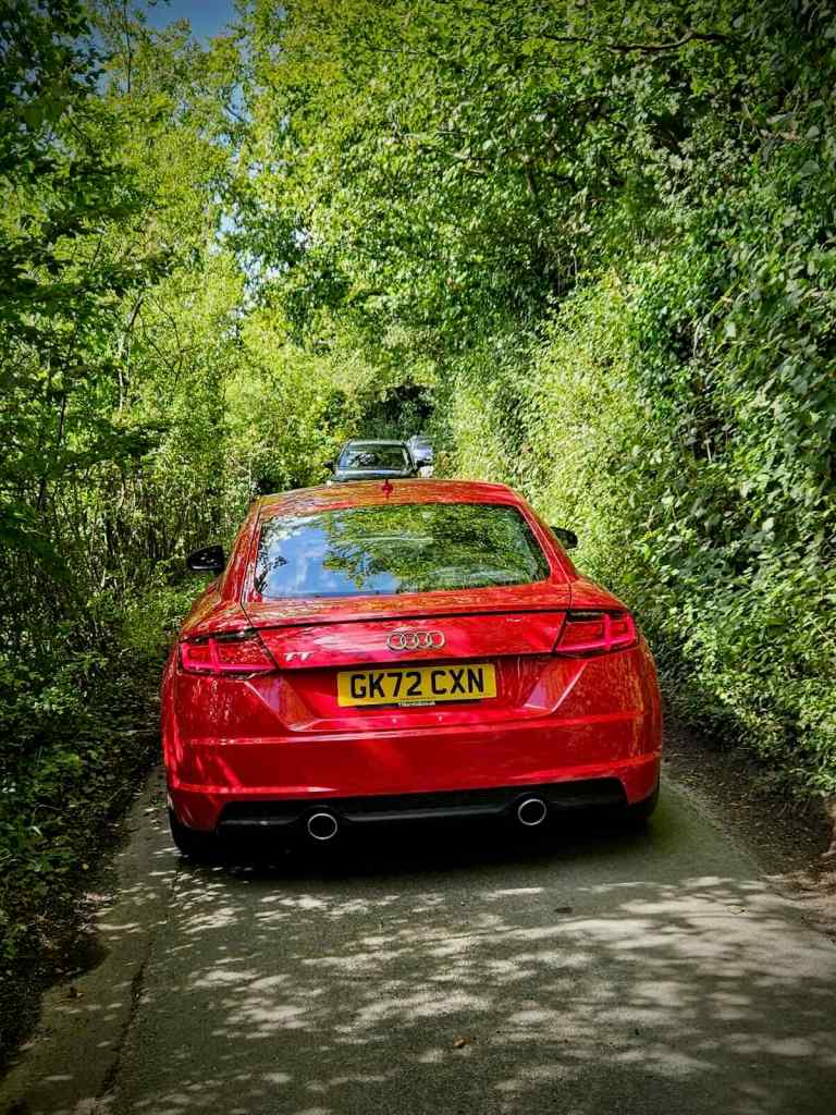 Cars blocking my way, as one reverses