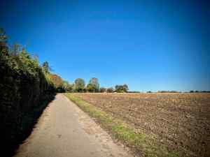 Riding along a gravel path next to farmland