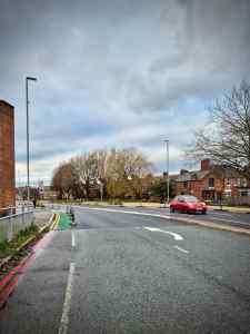 Just after the A56 junction, before the cycle path begins