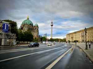 Painted lane on Unter den Linden, with the Berliner Dom, TV Tower and Humboldt Forum