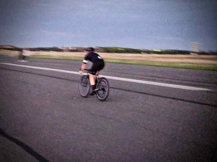 Person cycling on the runway at Tempelhofer Feld