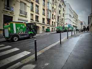 Street cleaning vans parked on Rue de la Villette