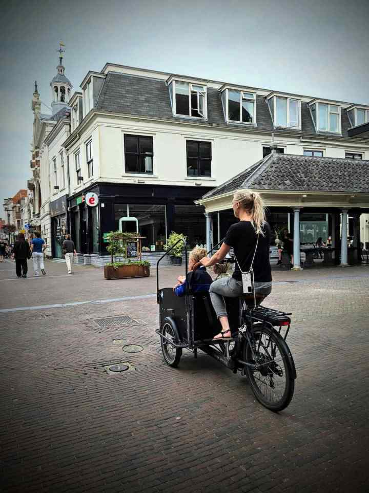 Riding along Langestraat on a cargo bike