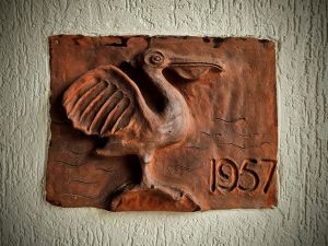 Pelican tile on wall, with 1957 inscribed