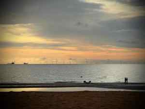 Looking out to sea, people on the beach