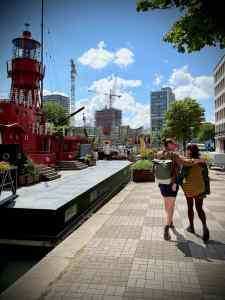 A couple walking past Vessel 11 on Wijnhaven