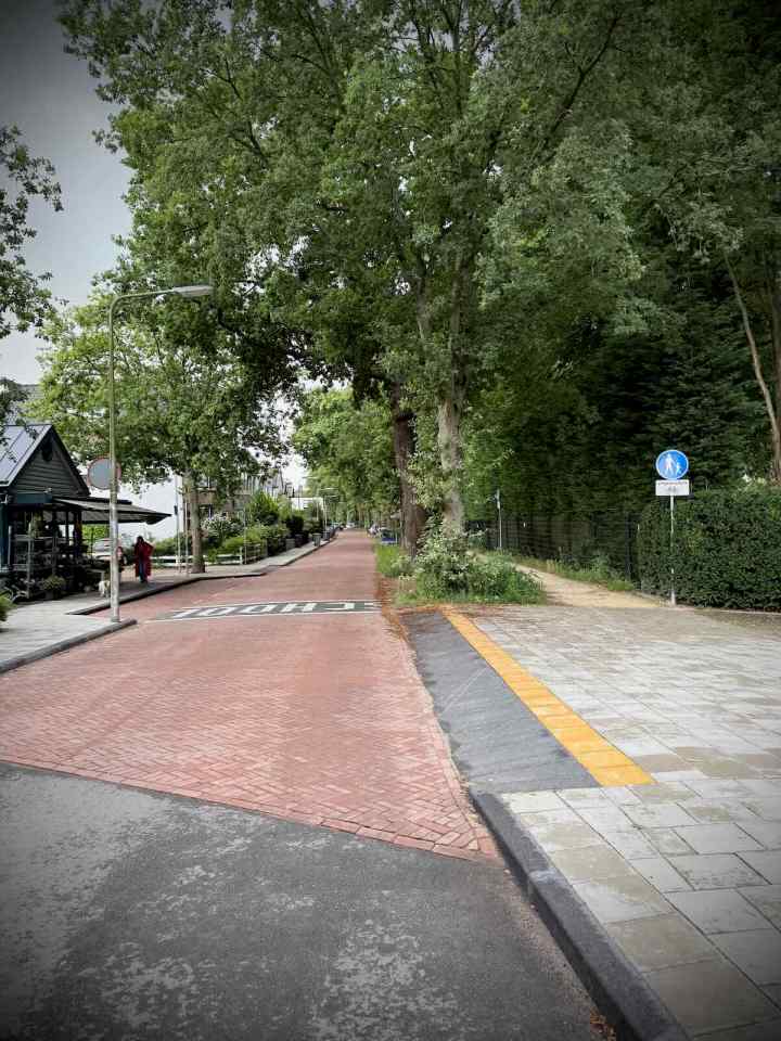 Reconstructed Schouwweg with a school sign