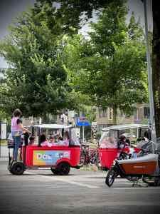 Kids in bike buses outside Kunstmuseum Den Haag