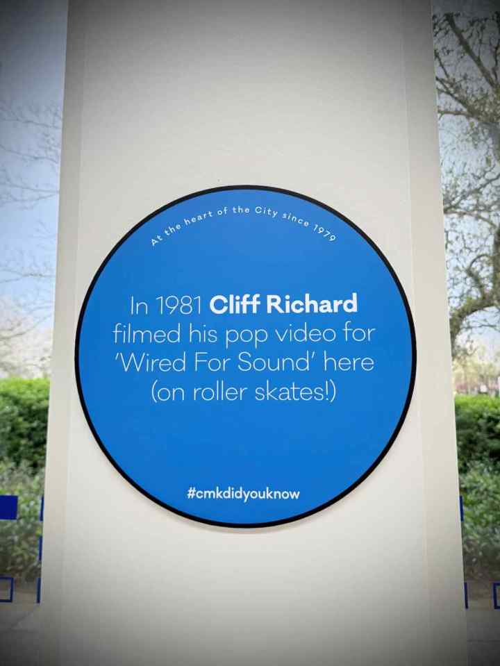 Blue plaque in Midsummer Arcade saying "In 1981 Cliff Richard filmed his pop video for 'Wired For Sound' here (in roller skates!)"