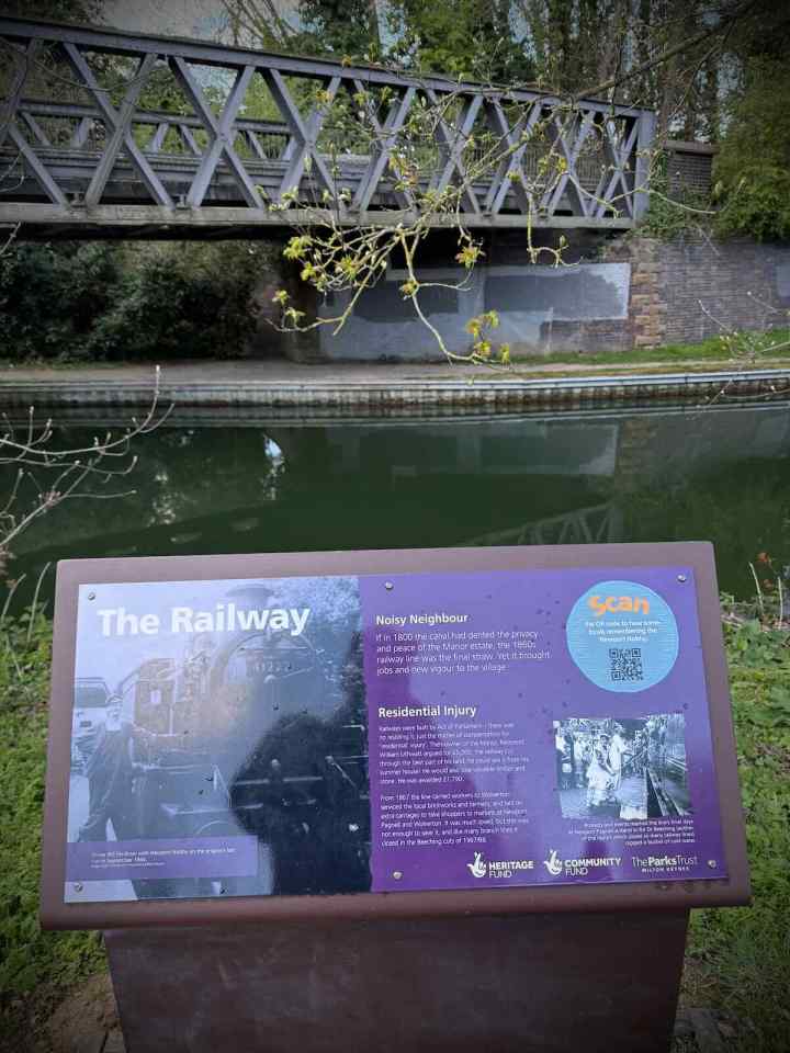 The Railway information board next to the Grand Union Canal and old railway bridge