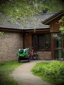 Cleaning staff bike outside a lodge