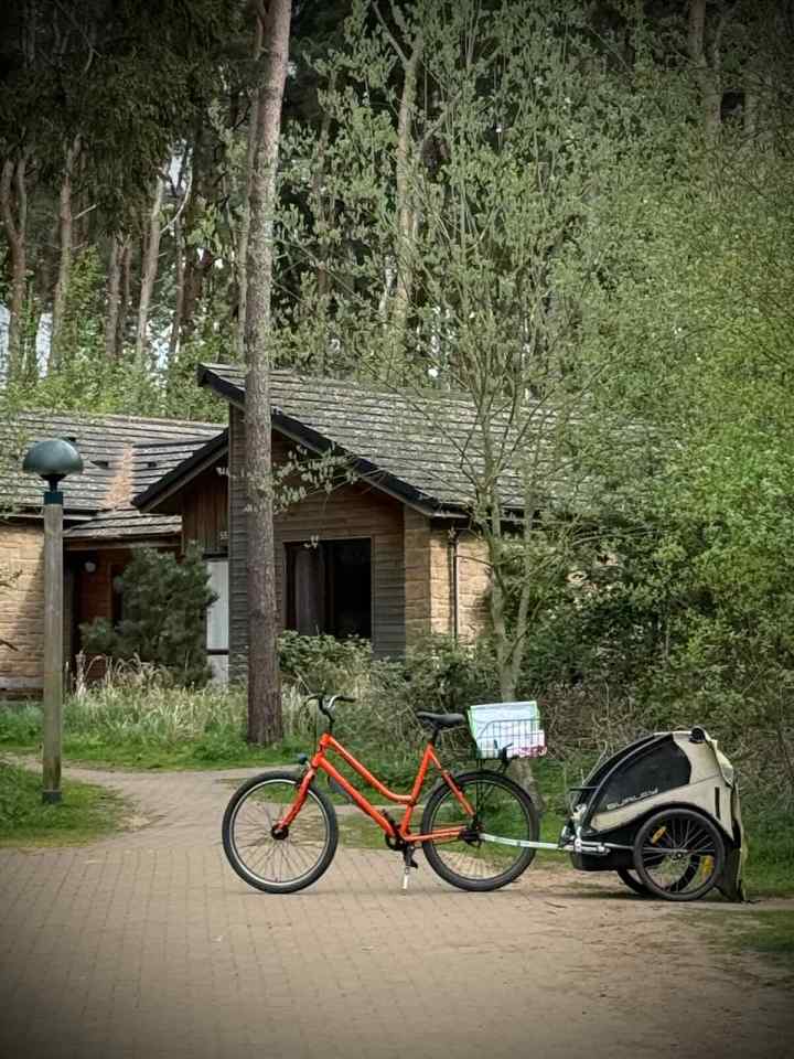 Cleaning staff bike outside a lodge