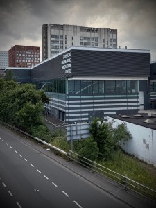 University of Manchester's Graphene Engineering Innovation Centre in front of the old UMIST Maths and Social Sciences Building